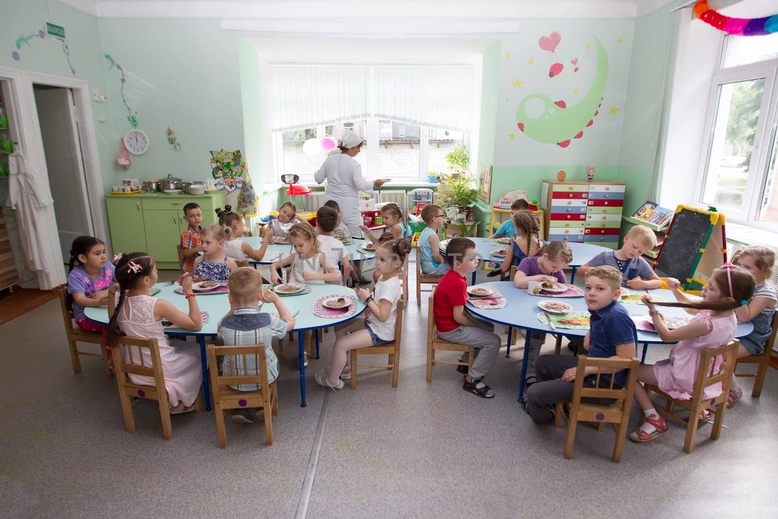 Belarus, Gomel, May 29, 2018. The kindergarten is central. Open Day.Many children in the kindergarten eat at the table.Lunch for children.