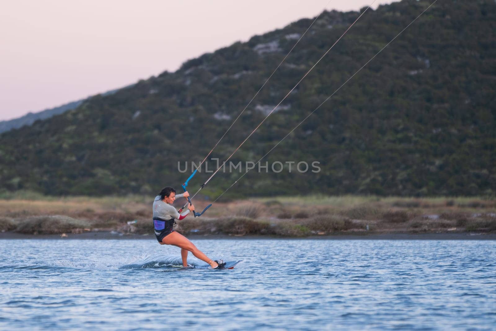 Gulbahce,Urla,Izmir,Turkey - July 30, 2023, People kite surf at the beach on a sunny afternoon in Gulbahce , Urla Izmir. High quality photo