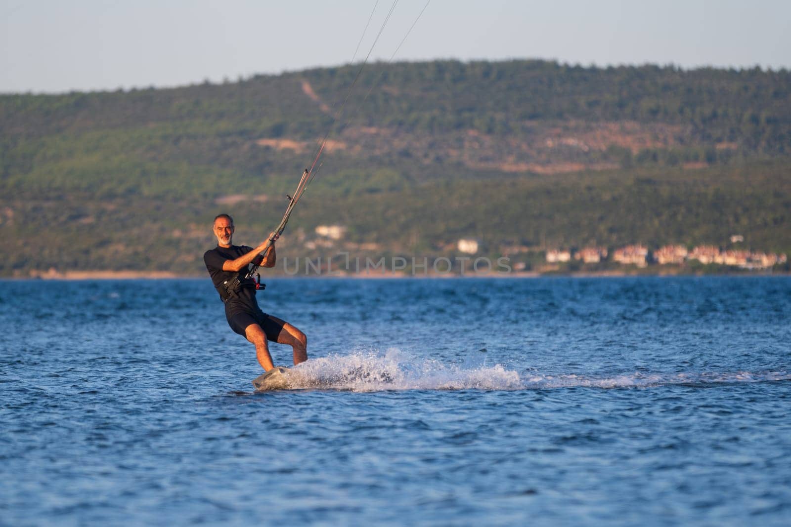 Gulbahce,Urla,Izmir,Turkey - July 30, 2023, People kite surf at the beach on a sunny afternoon in Gulbahce , Urla Izmir. High quality photo