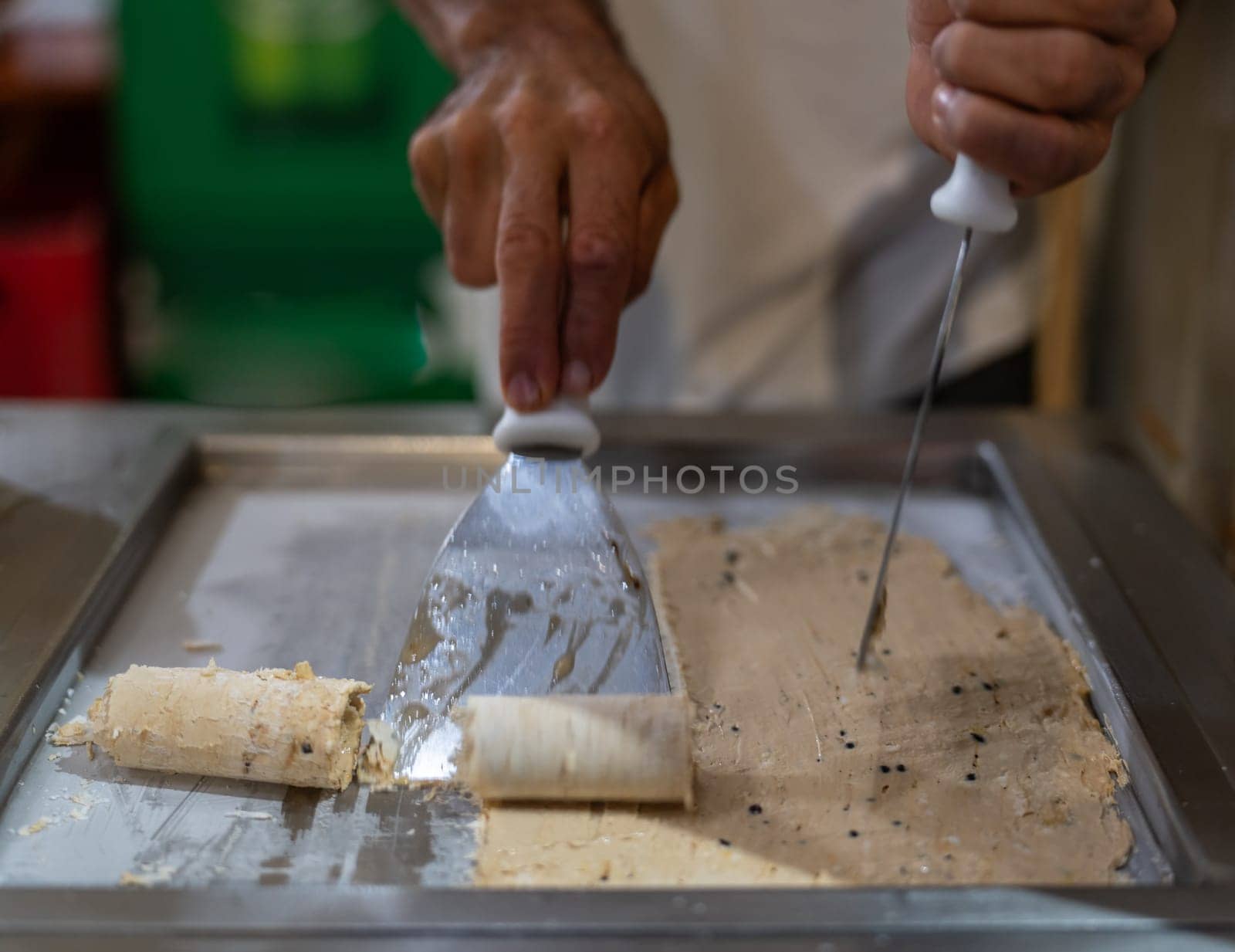 Artisan Crafting Rolled Ice Cream on a Hot Plate Indoors by FerradalFCG