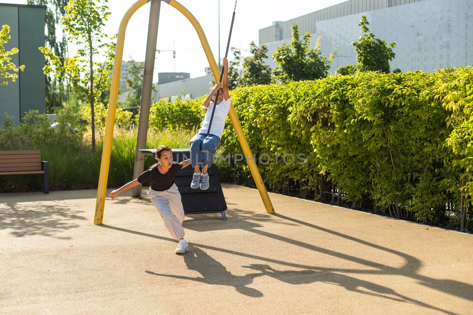 Girl playing on a swing in the park. High quality photo