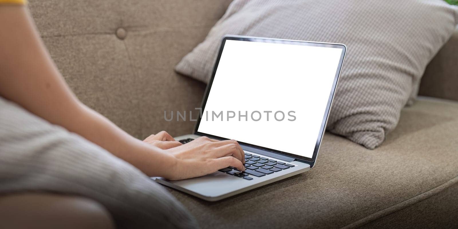 Young female with laptop at home on white blank screen for montage mockup display device in concept of lifestyle work at home by nateemee