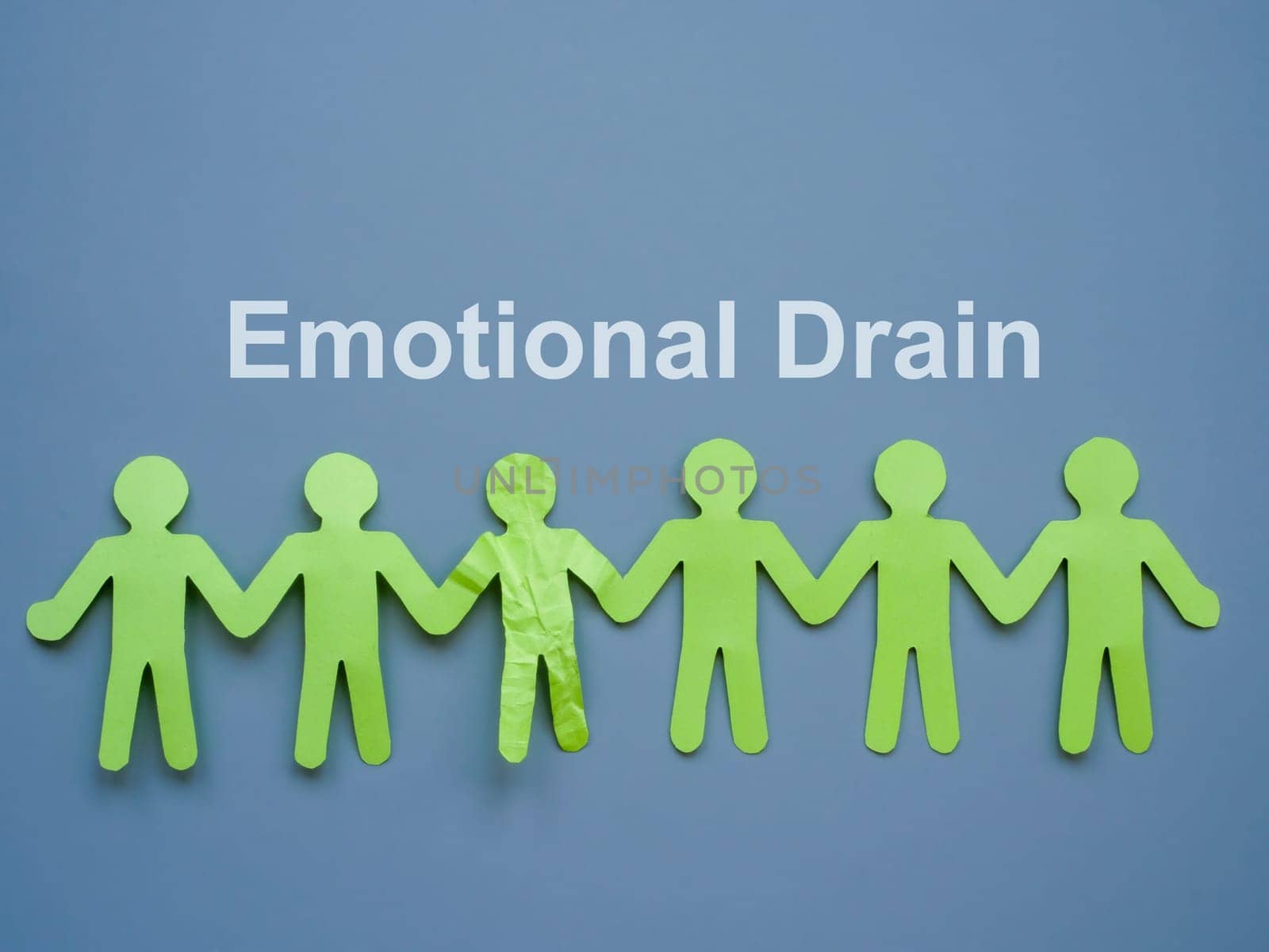 Emotional drain abstract. Paper people and one crumpled one. by designer491