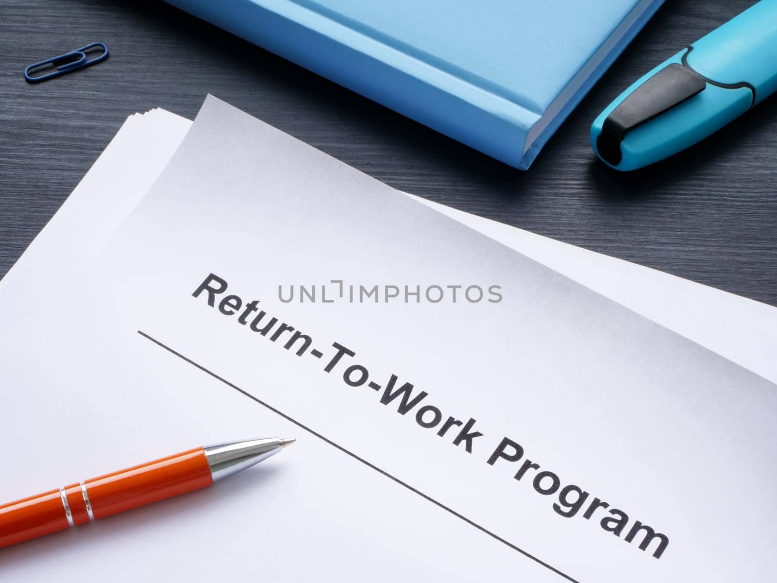 Papers with return-to-work program and a pen.