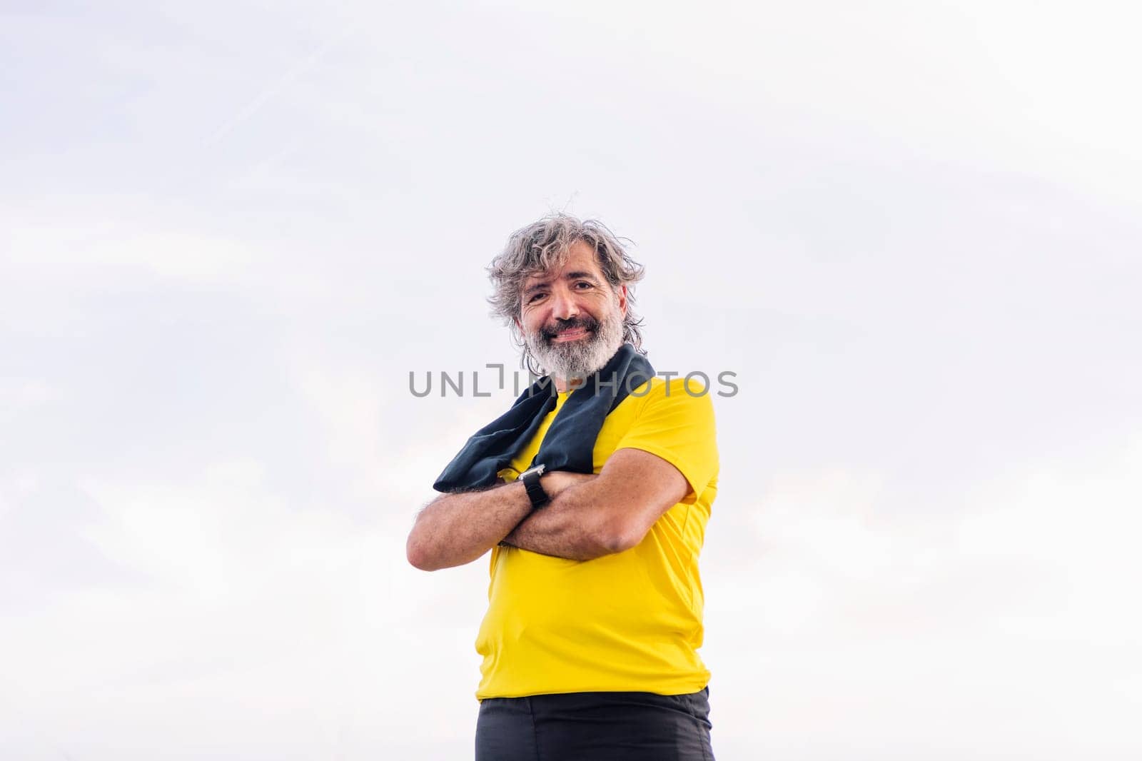 senior sports man posing happy with arms crossed by raulmelldo