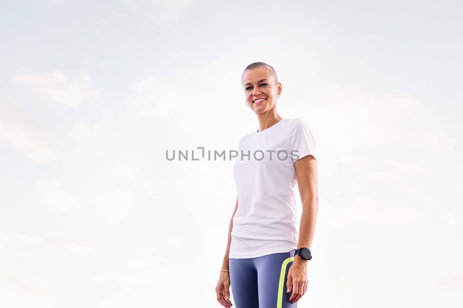 sports woman smiling happy looking at camera, concept of active and healthy lifestyle, copy space for text