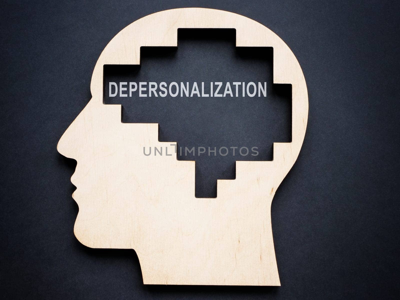 Depersonalization concept. Wooden outline of the head. by designer491