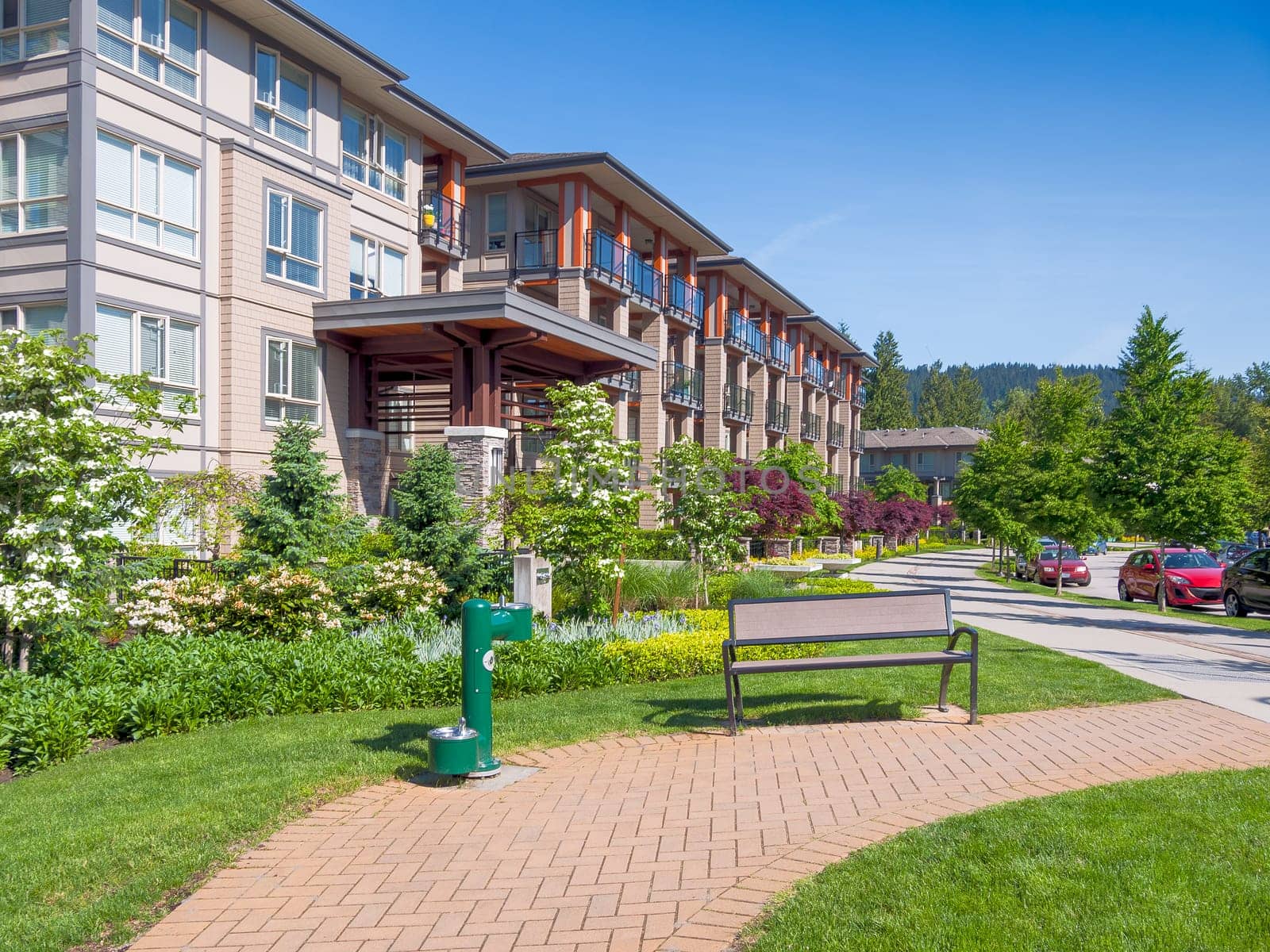 Walkway along modern apartment building on bright, sunny day in Vancouver, Canada.