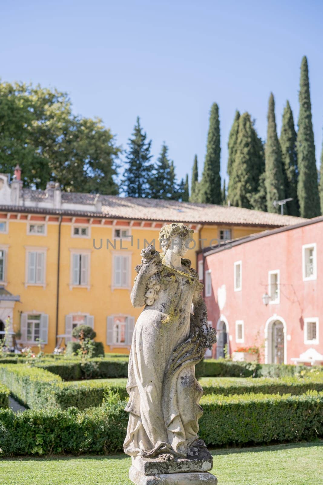 Sculpture of a woman on a pedestal in the garden of an ancient villa. High quality photo