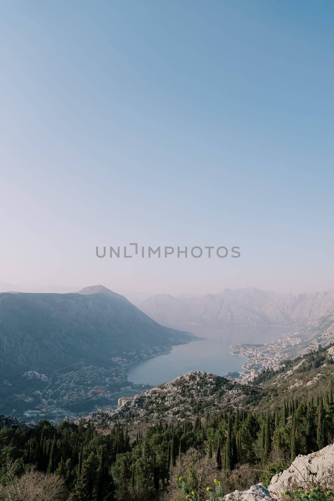 View from the mountain to the valley of the Bay of Kotor surrounded by mountains in a light haze. Montenegro. High quality photo