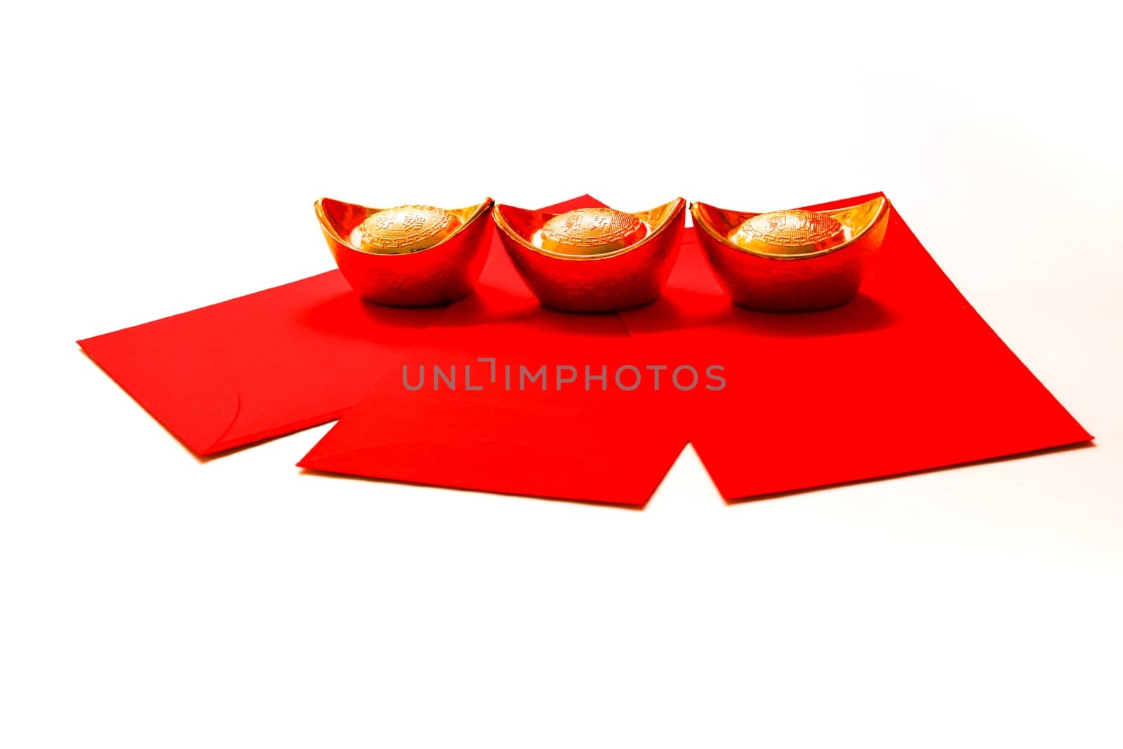 Chinese New Year Spring festival decorations red packet and gold ingots on white background. Chinese translation : good fortune, good luck, wealth, and money flow.