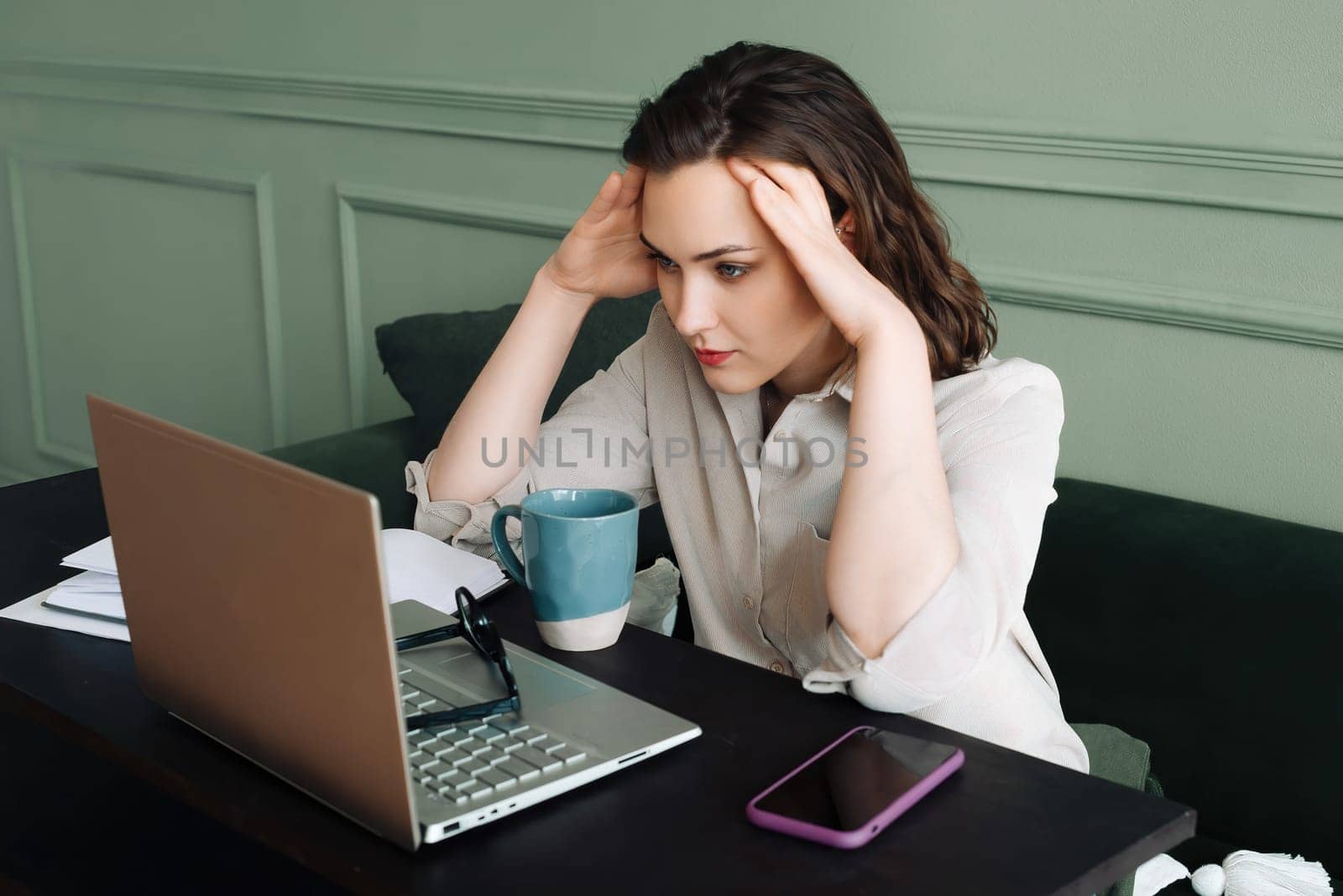 Stressful Workday. Tired Woman Coping with Fatigue and Health Issues. Exhausted Woman Struggling with Fatigue, Blood Pressure, and Headaches While Staring at Laptop.