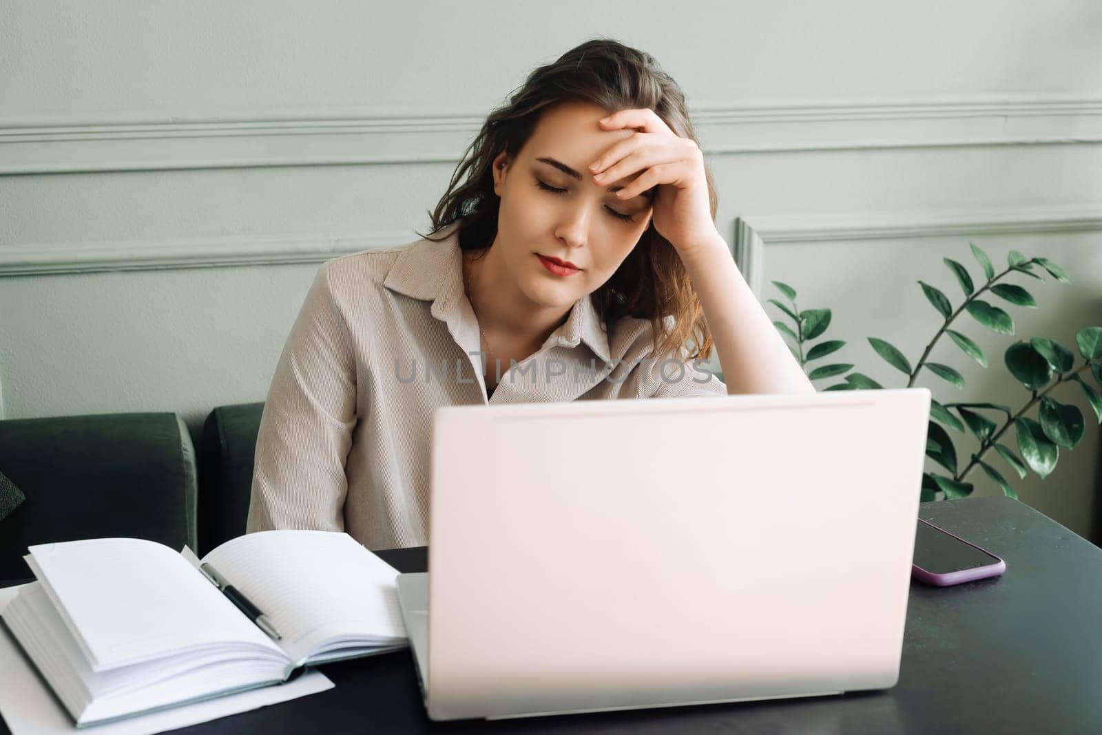 Work-Induced Weariness. Young Woman Suffers from Overwork and Stress. Modern-Day Struggles. Woman Overwhelmed by Overwork and Stress. Young Woman Sleeps at Laptop, Overworked and Stressed.