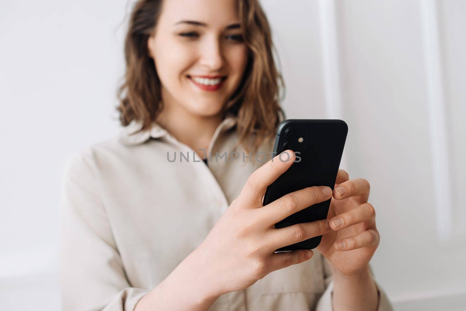 Connected and Content. Woman Typing, Chatting, and Watching Videos on Phone. Interactive Engagement. Smiling Woman Multitasks on Smartphone with Joy. Cheerful Woman Typing, Viewing on Smartphone.