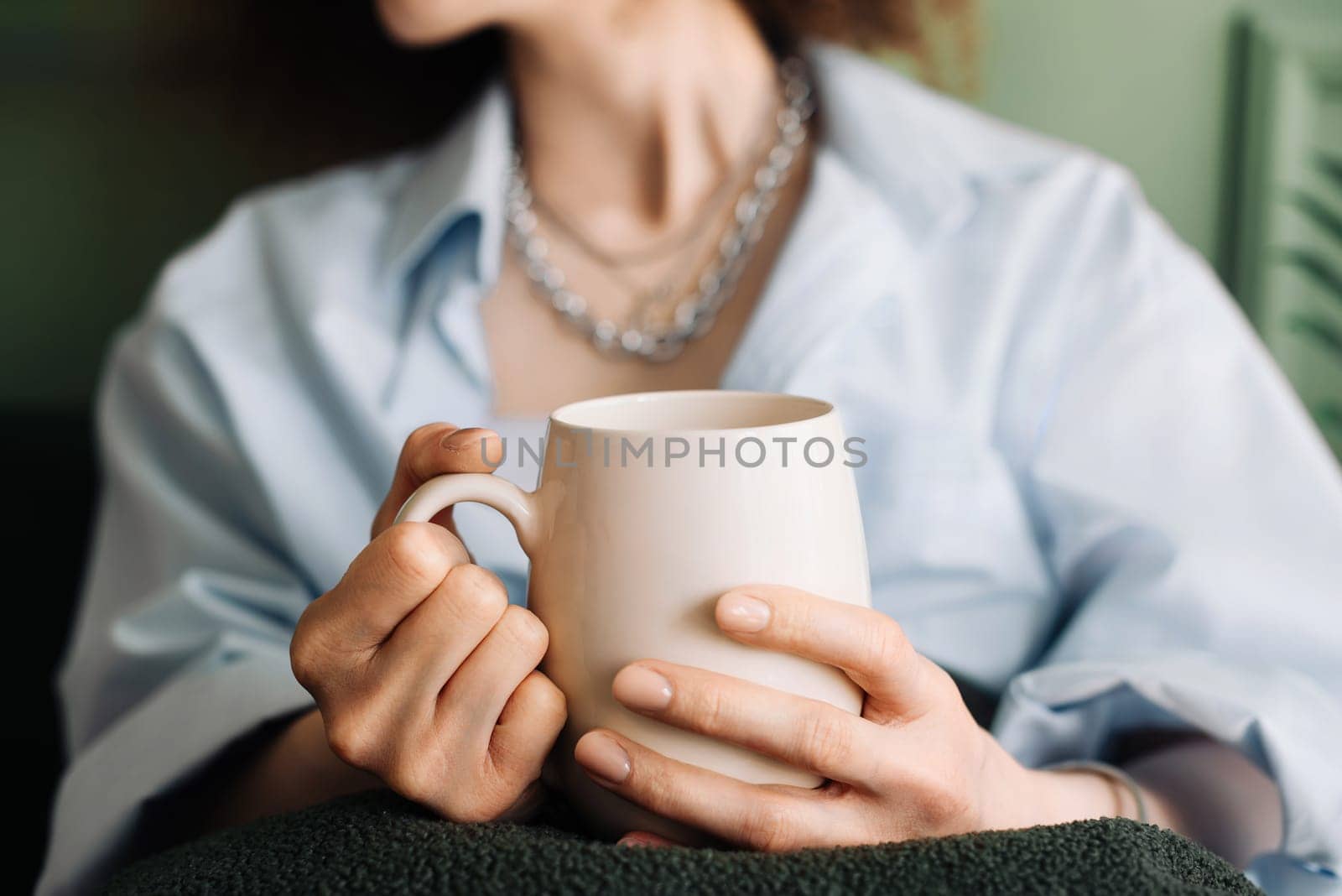 Millennial Woman Relaxing with Tea on Living Room Couch, Cropped Interior View. Leisure Time. Young Woman Enjoying Relaxation and Tea in Living Room Interior