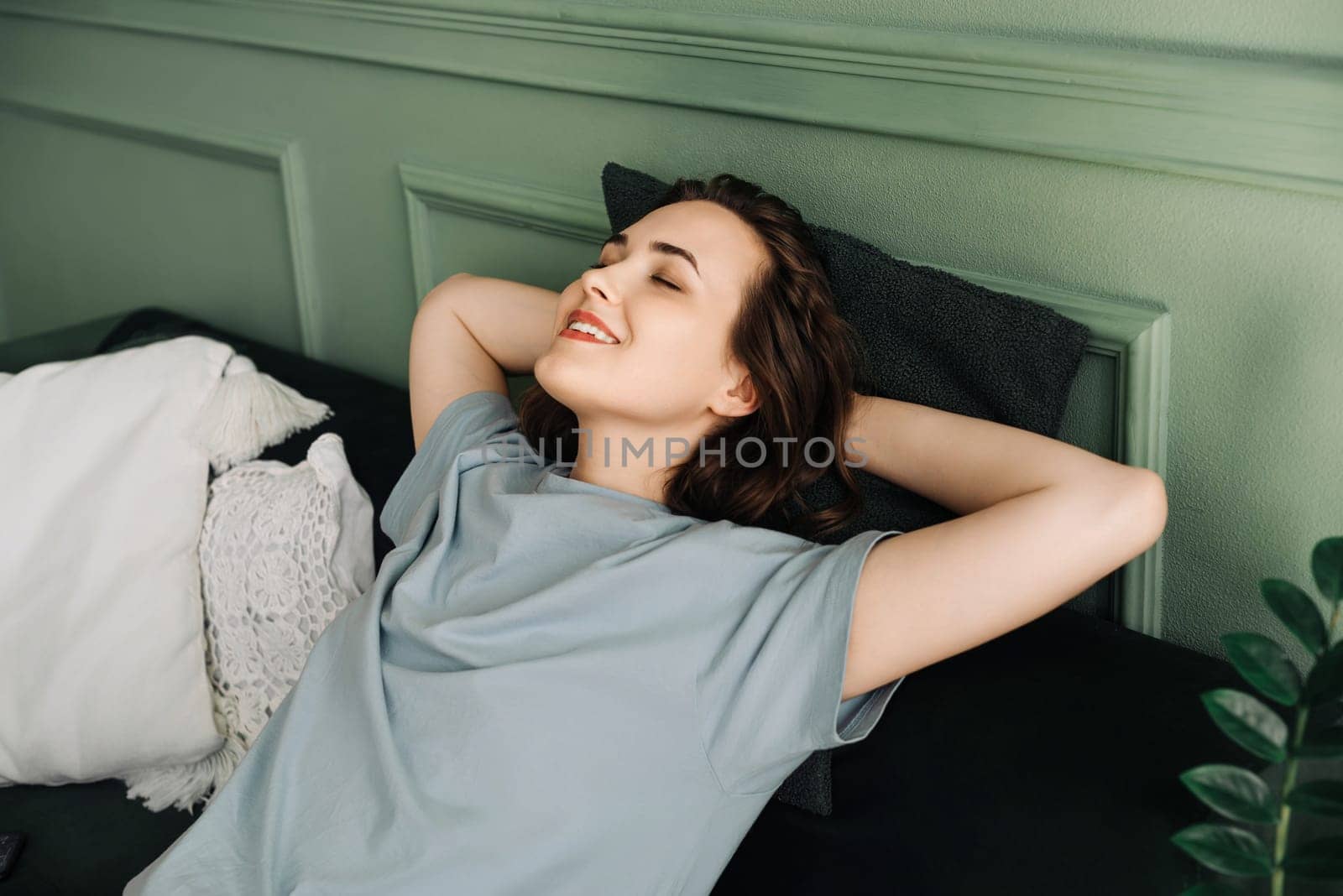 Restful Respite. Smiling Woman Embraces Tranquil Nap on Couch. Calm Repose. Joyful Woman Enjoys Serene Sleep on Living Room Sofa. Tranquil Dreaming. Serenity in Rest.