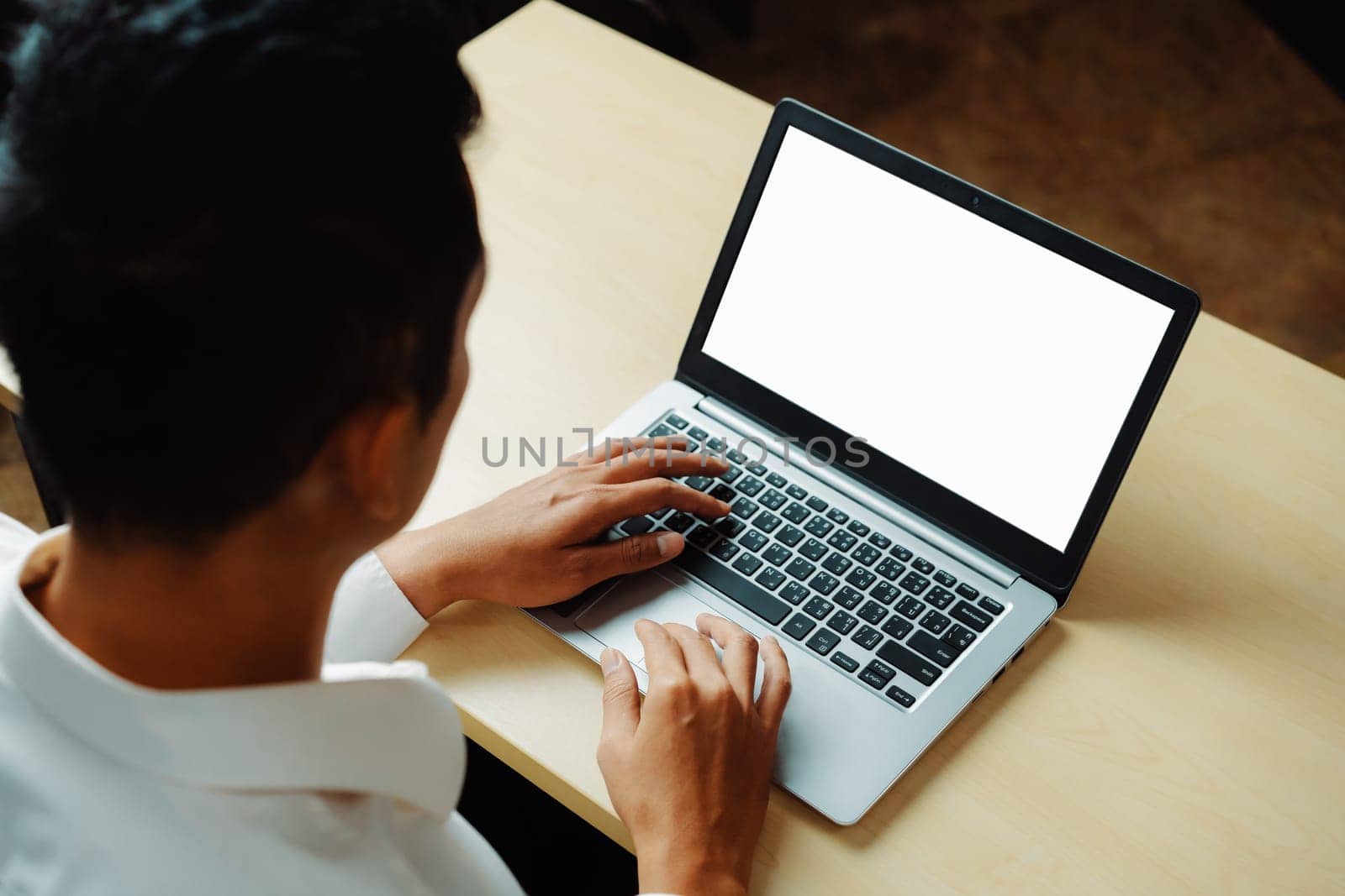 Business person or office worker using laptop computer while sitting at desk. uds