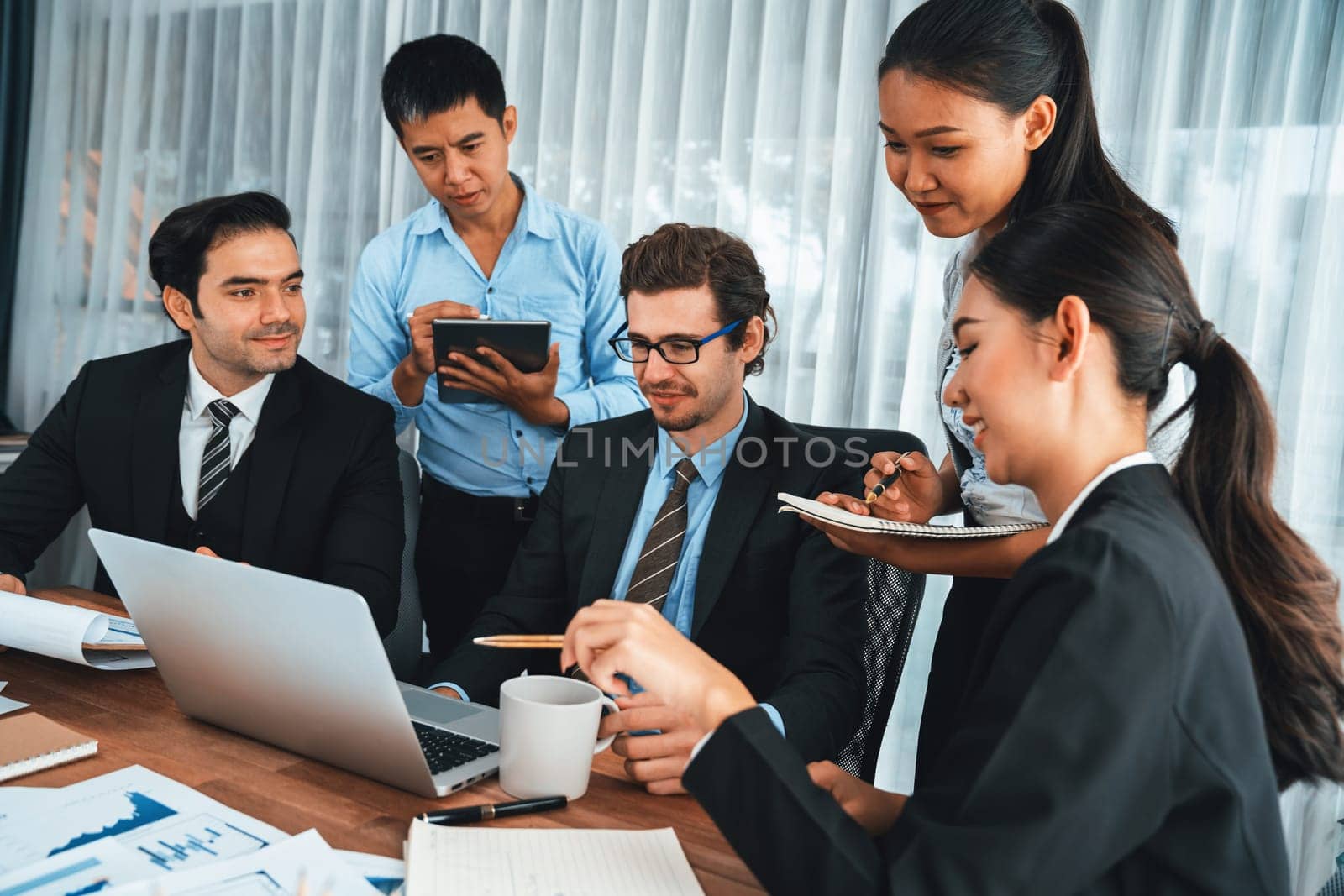 Diverse group of business analyst team analyzing financial data report paper on office table. Chart and graph dashboard by business intelligence analysis for strategic marketing planning Habiliment