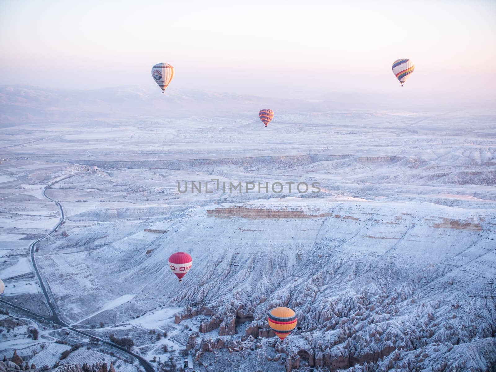 Colorful balloons over volcanic rocks in Cappadocia. Turkey