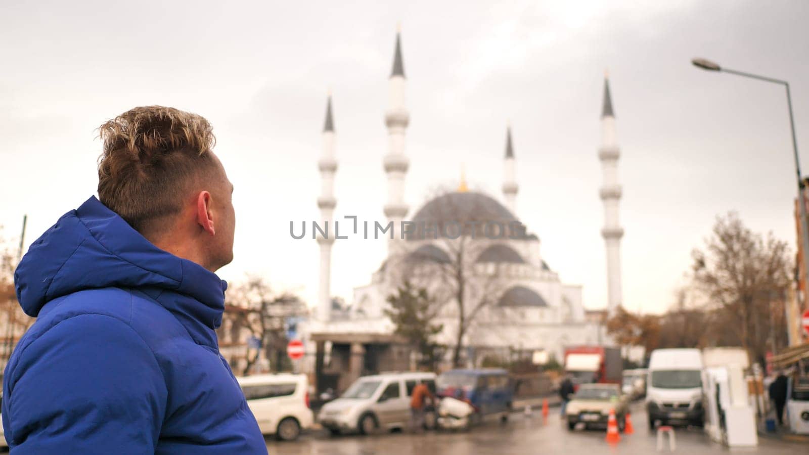 Tourist in the winter against the background of a mosque in Ankara
