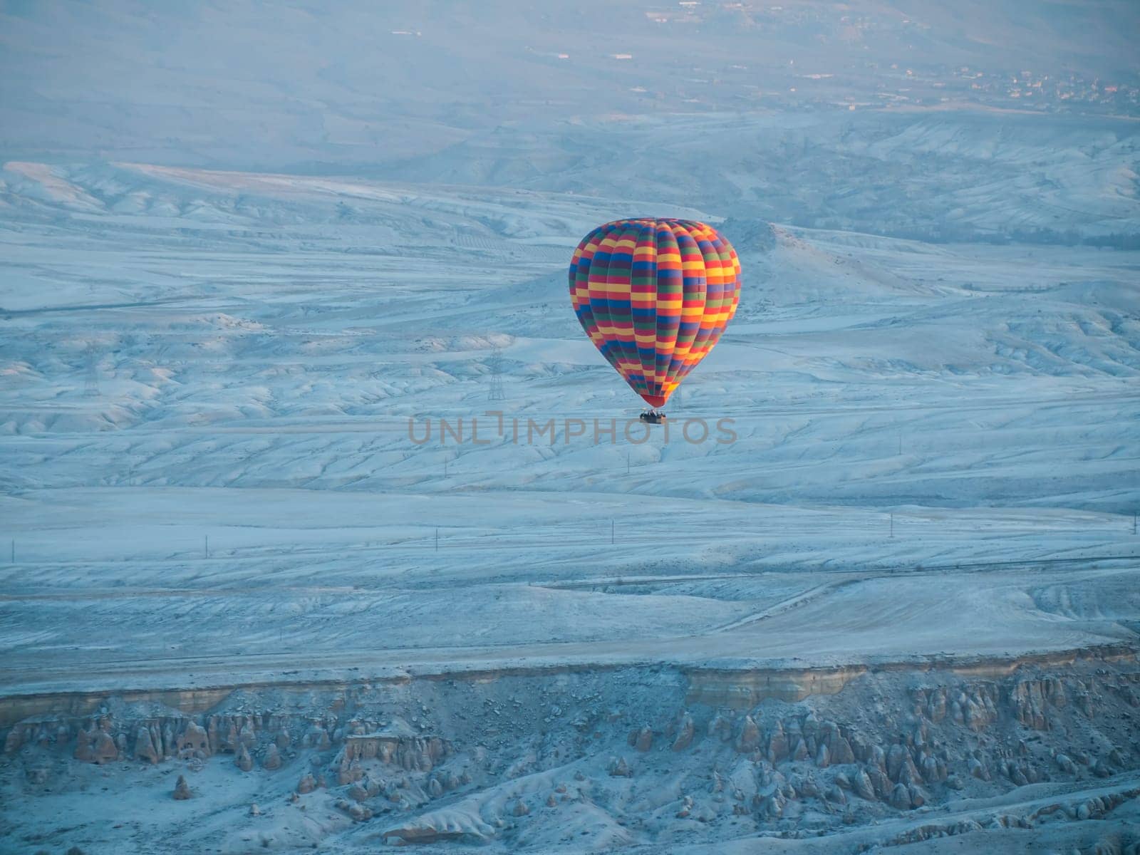 Colorful balloons over volcanic rocks in Cappadocia. Turkey