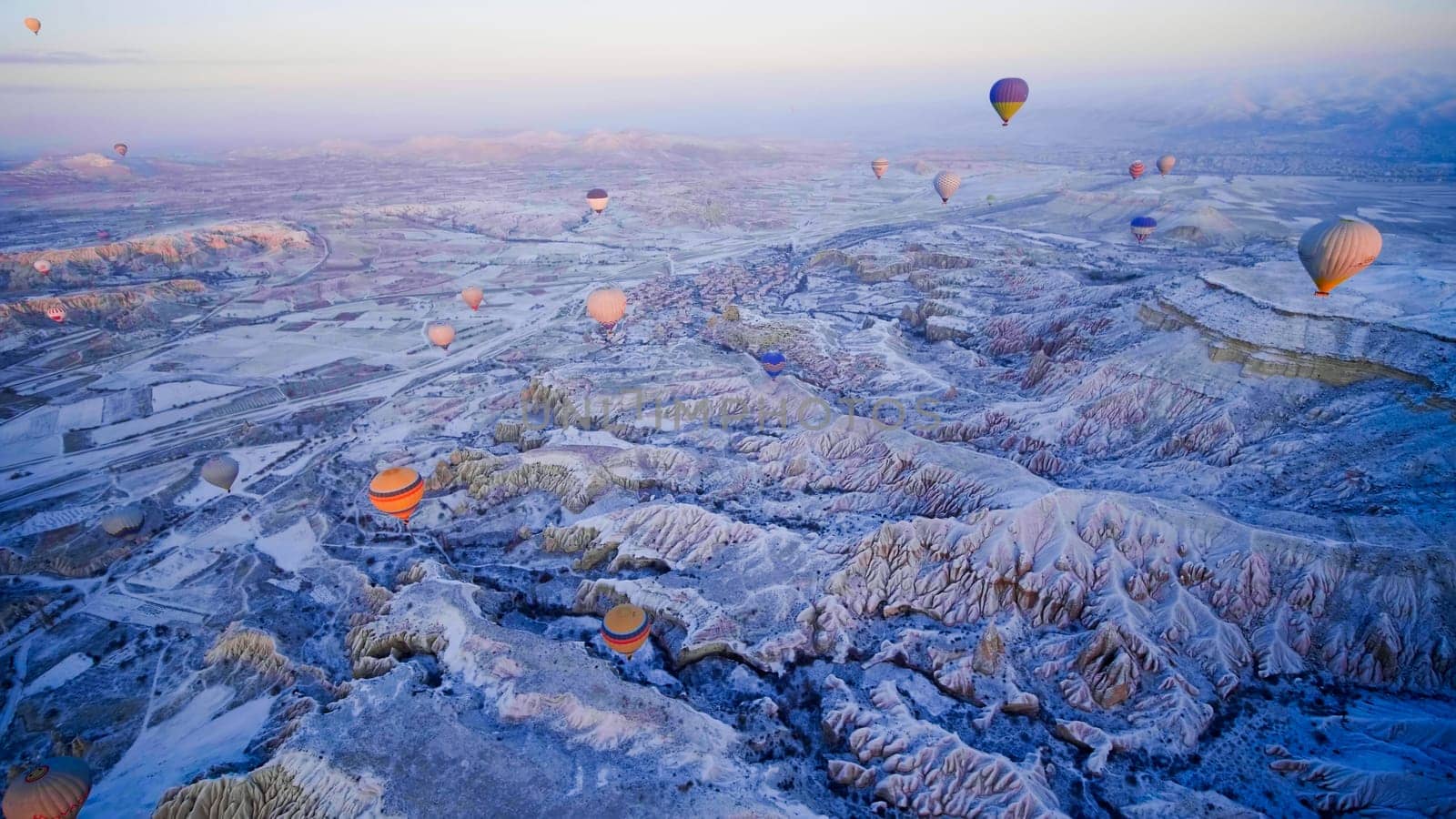 Colorful balloons over volcanic rocks in Cappadocia. Turkey