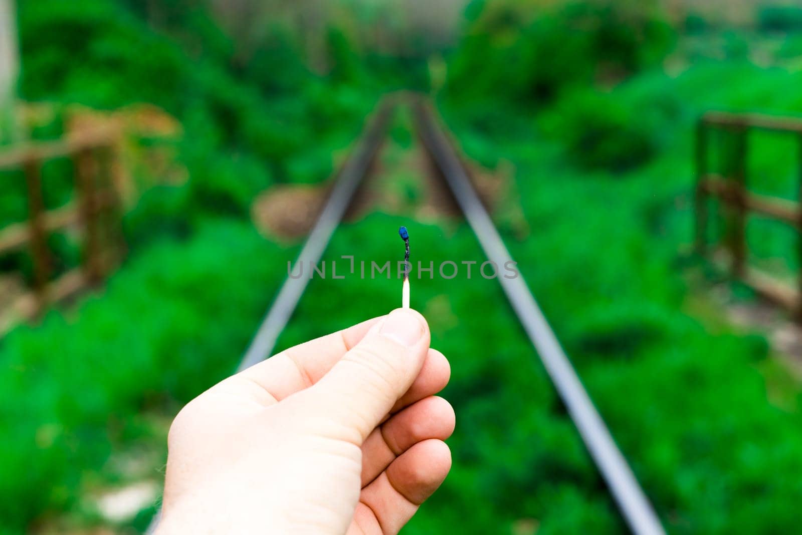 Matches on a rails railroad tracks background, fire on railways concept