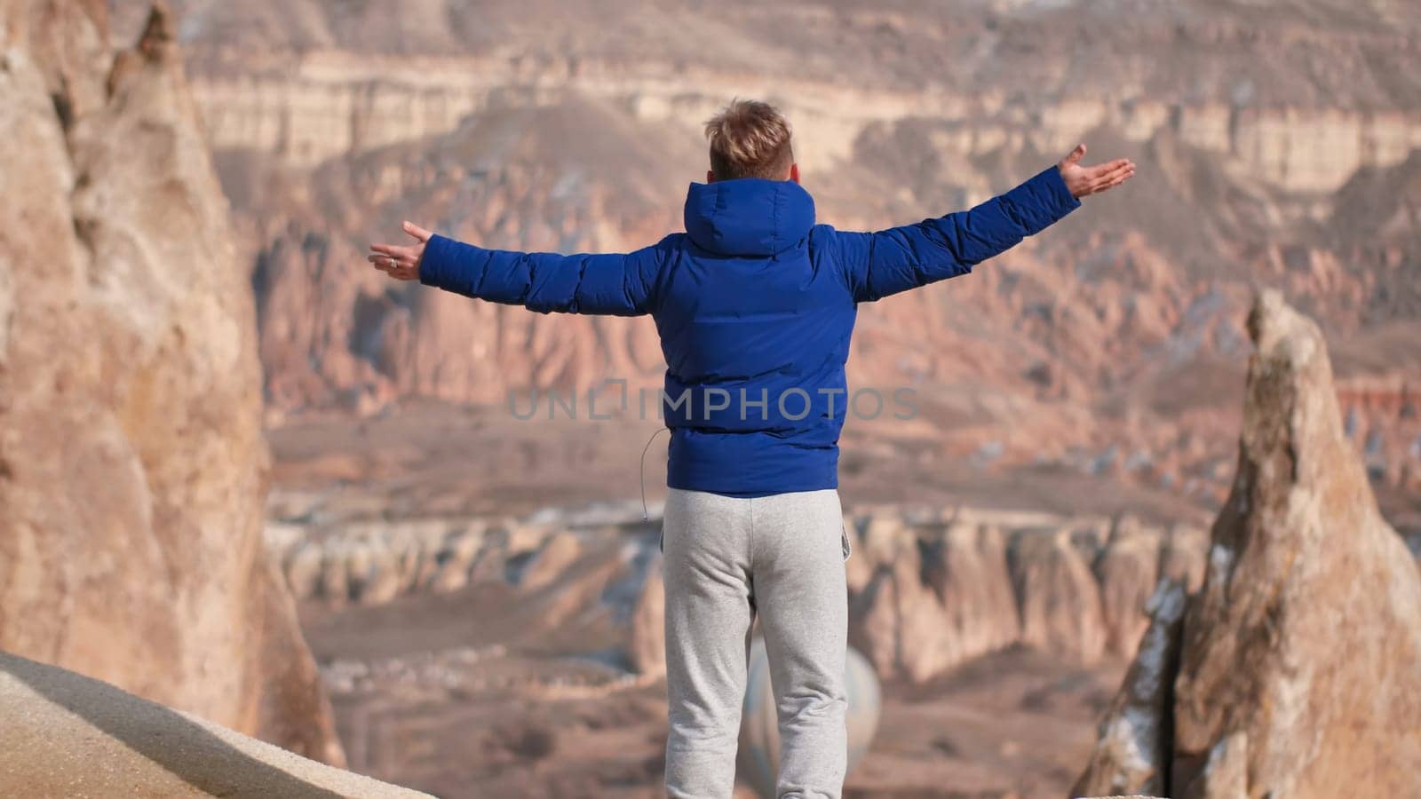 A young man ascended the rocks in Cappadocia