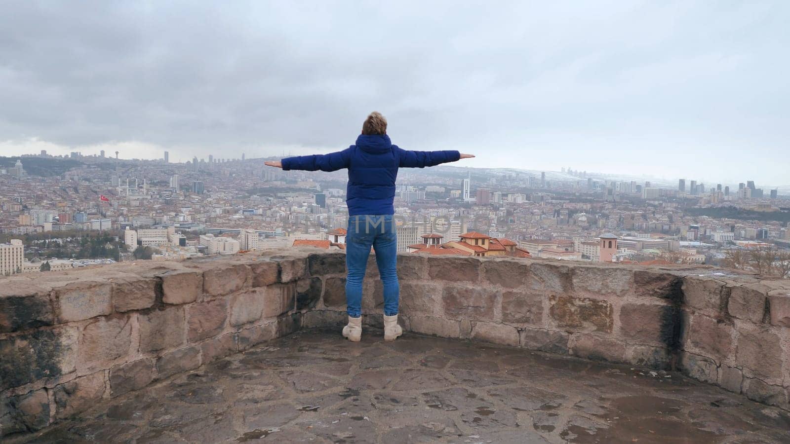 A guy with spread arms admires the capital of Turkey, Ankara. by DovidPro
