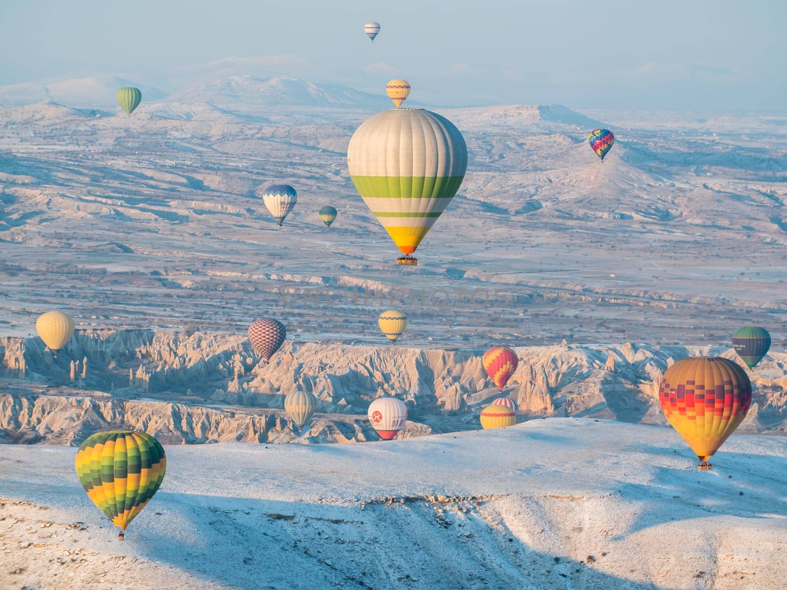 Colorful balloons over volcanic rocks in Cappadocia. Turkey