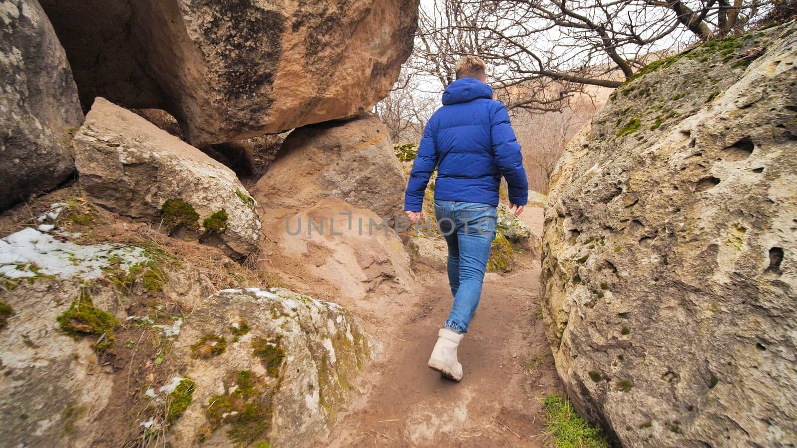 A tourist strolling among the rocks in the Ihlara Valley in Cappadocia, Turkey