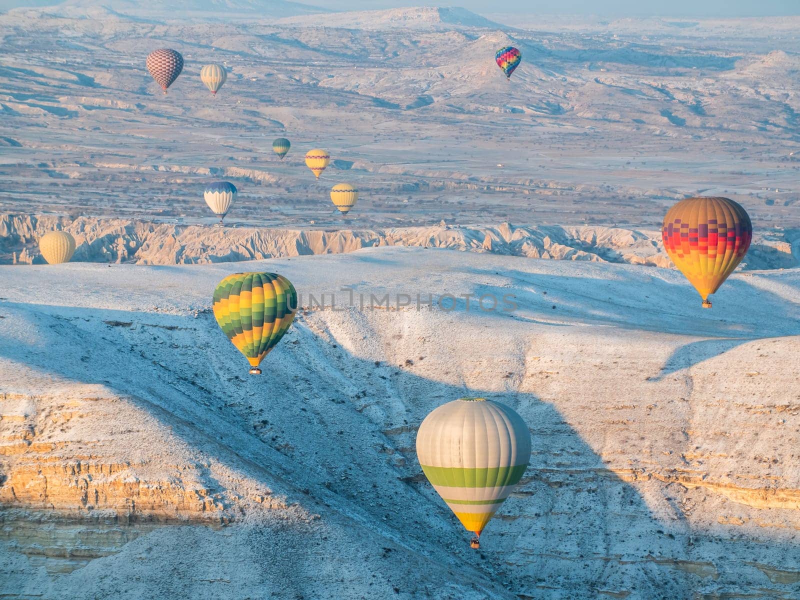 Colorful balloons over volcanic rocks in Cappadocia. Turkey