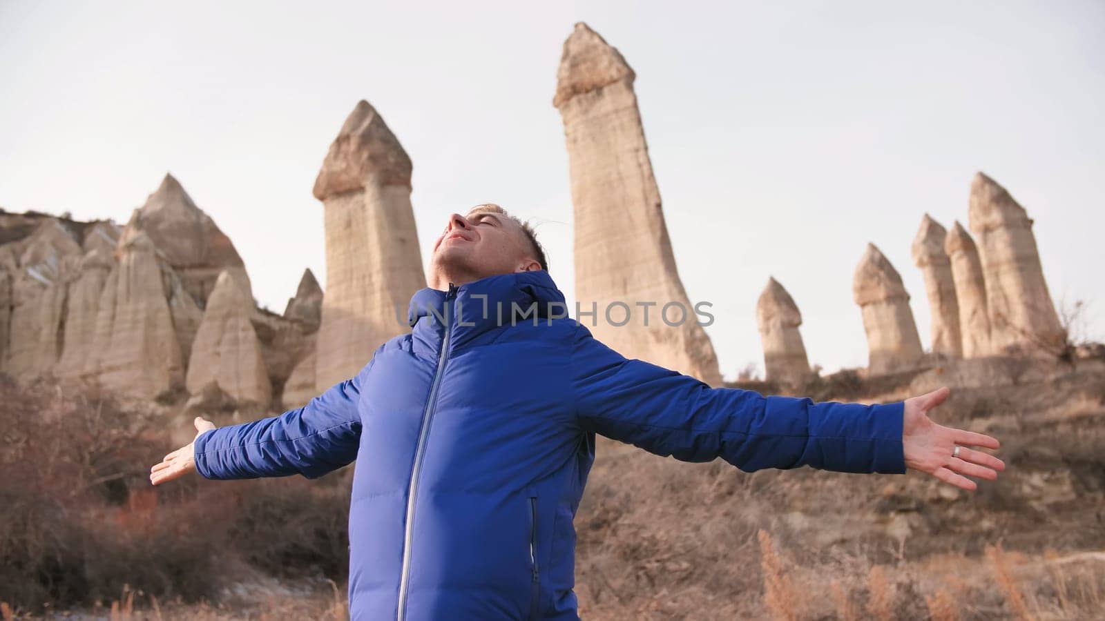 Russian tourist energized in the Valley of Love in Goreme Cappadocia Turkey during the freezing winter months