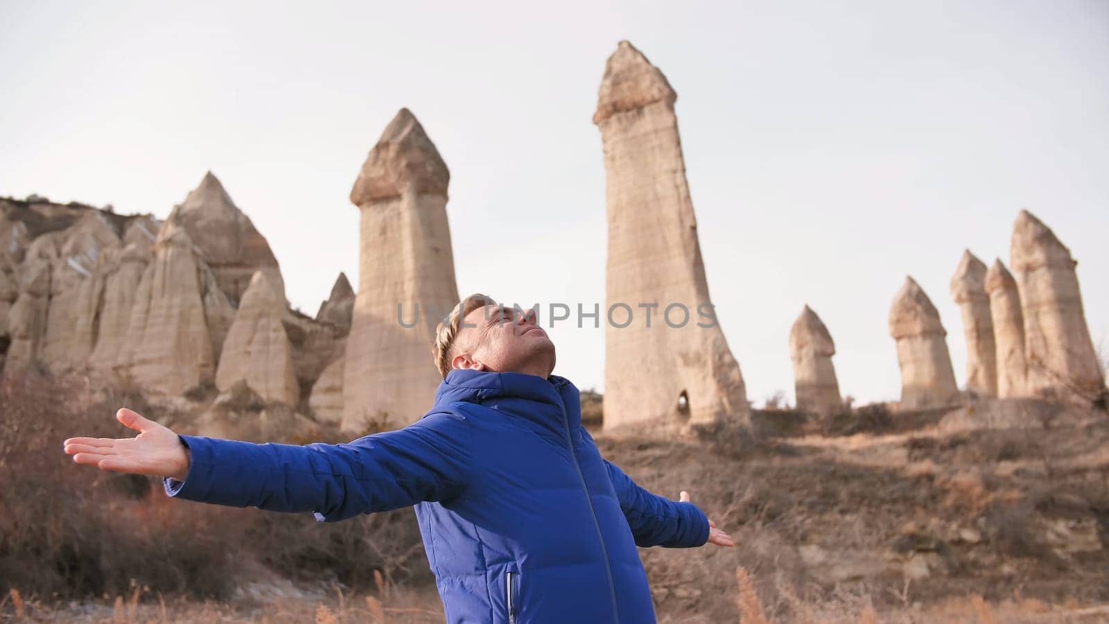 Russian tourist energized in the Valley of Love in Goreme Cappadocia Turkey during the freezing winter months
