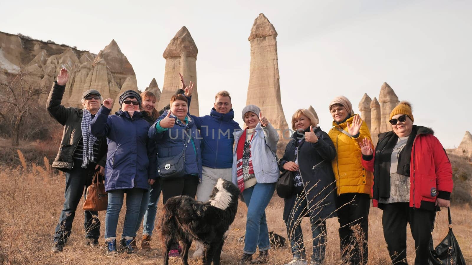 Russian tourists posing in the Valley of Love in Goreme Cappadocia Turkey during the freezing winter months