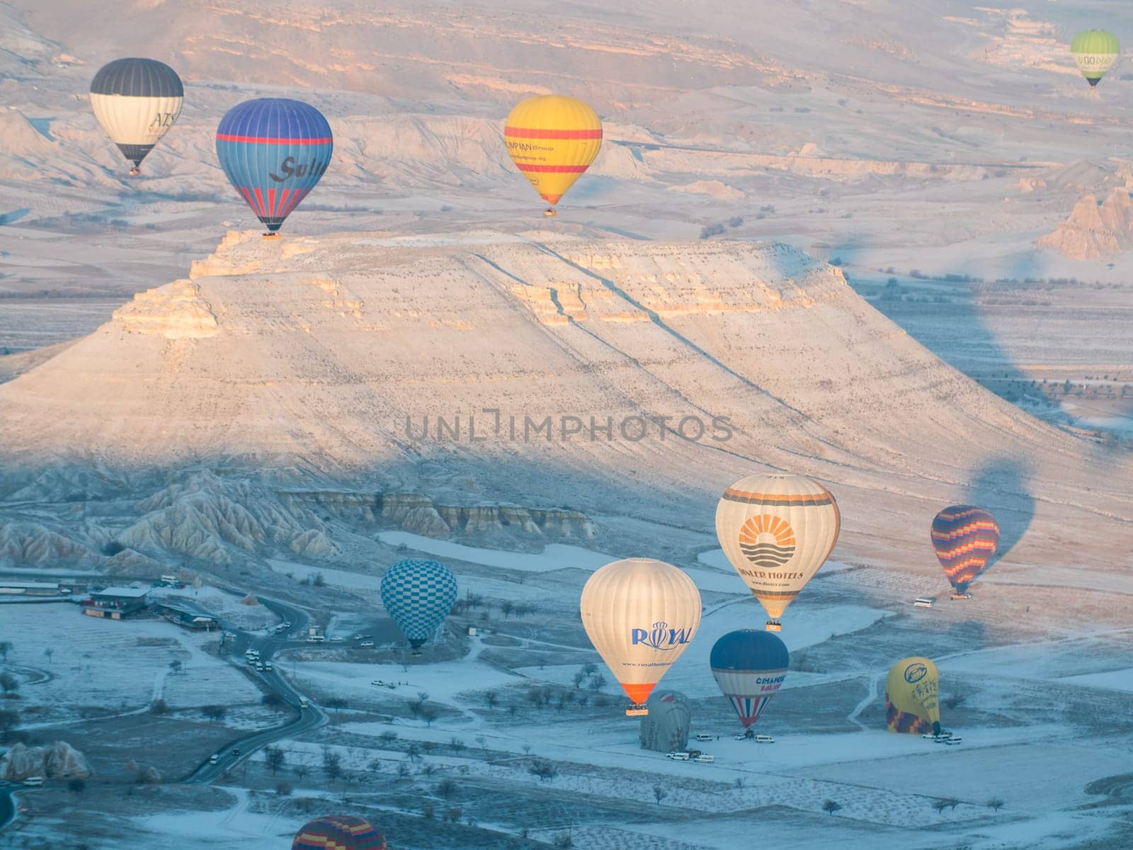 Colorful balloons over volcanic rocks in Cappadocia. Turkey