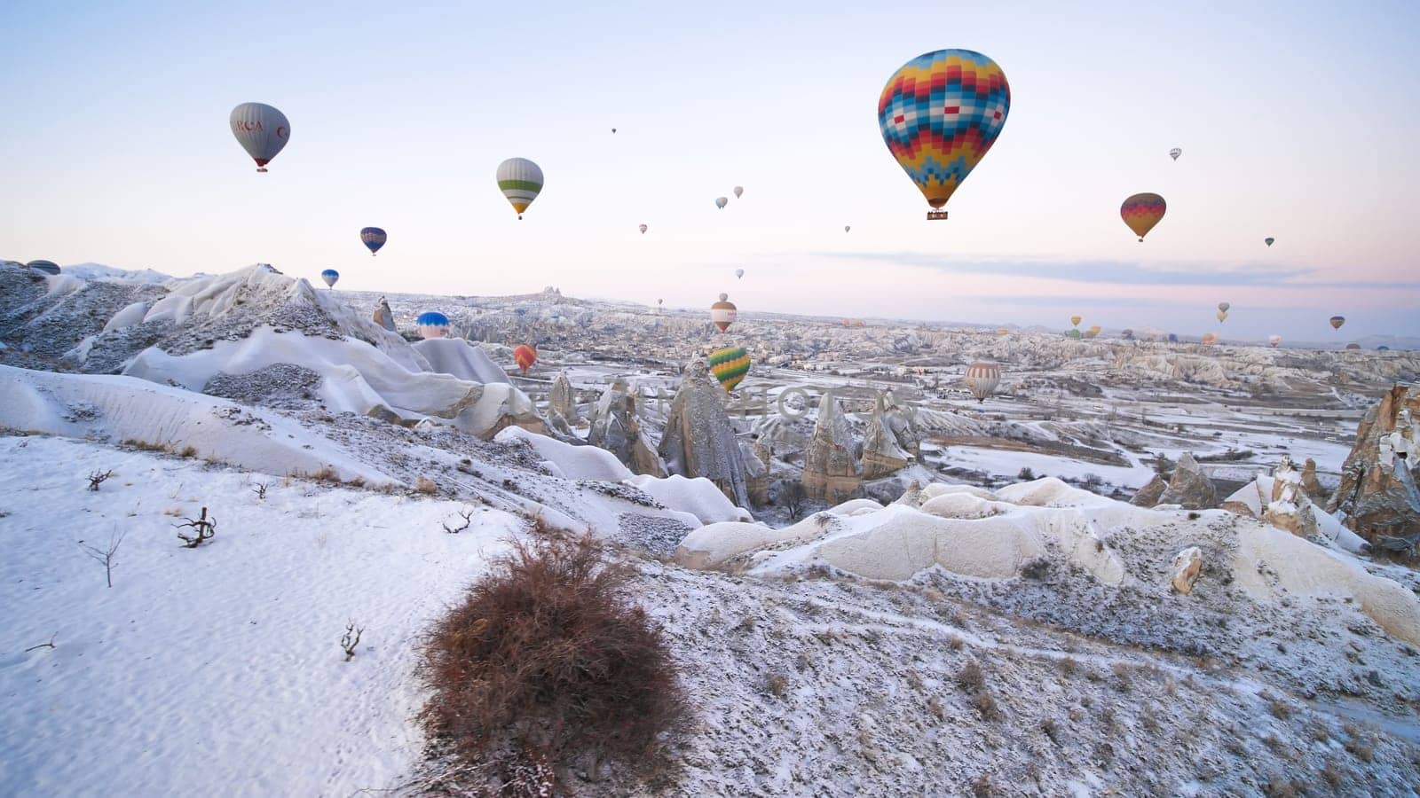 Cappadocia, Turkey - January 6, 2020: Color balloons in the sunrise sky. Cappadocia, Turkey. by DovidPro