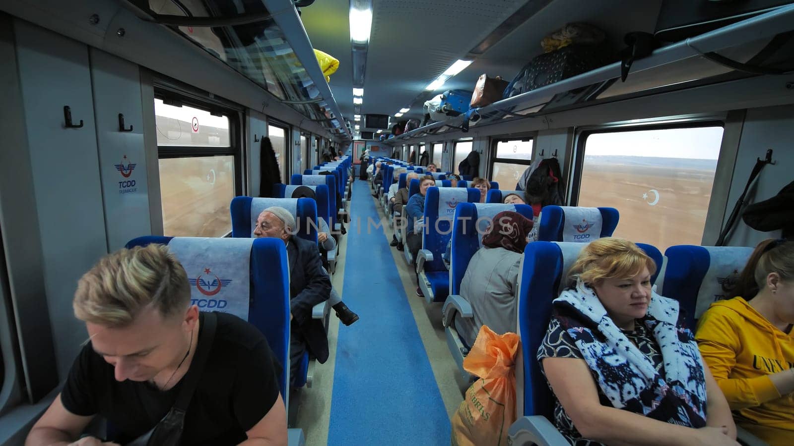 Ankara, Turkey - January 9, 2020: Wagon of a passenger train with passengers in Turkey. by DovidPro
