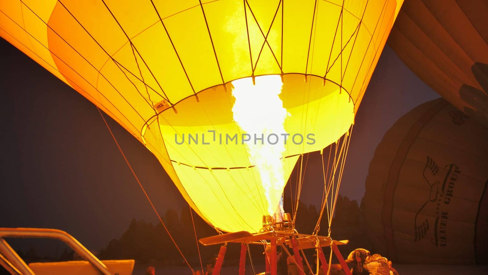 Cappadocia, Turkey - January 6, 2020: Heating the balloon with fire. Turkey. Cappadocia. by DovidPro