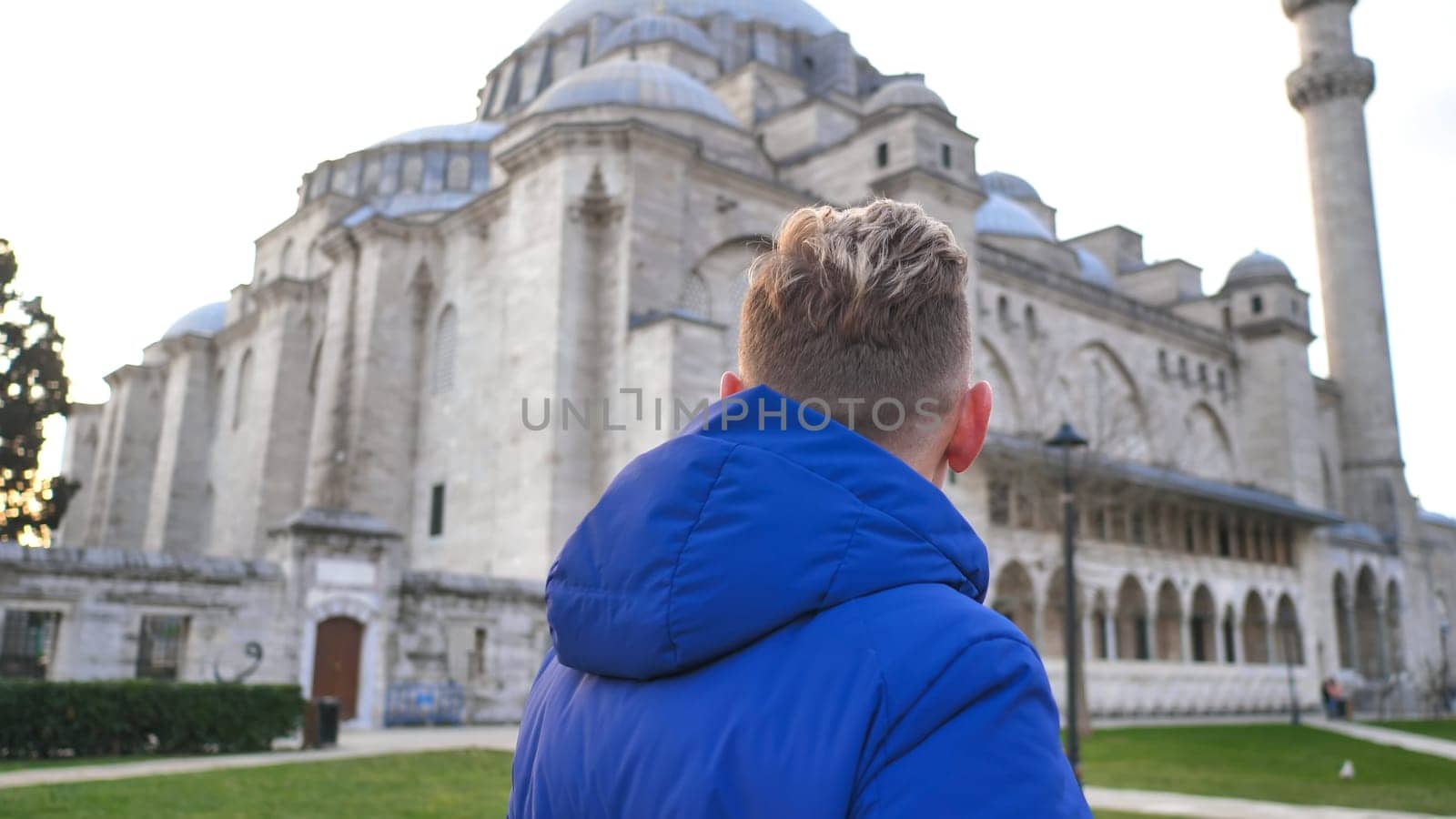 A male tourist is looking at the mosque of Sultan Suleiman in Istanbul.