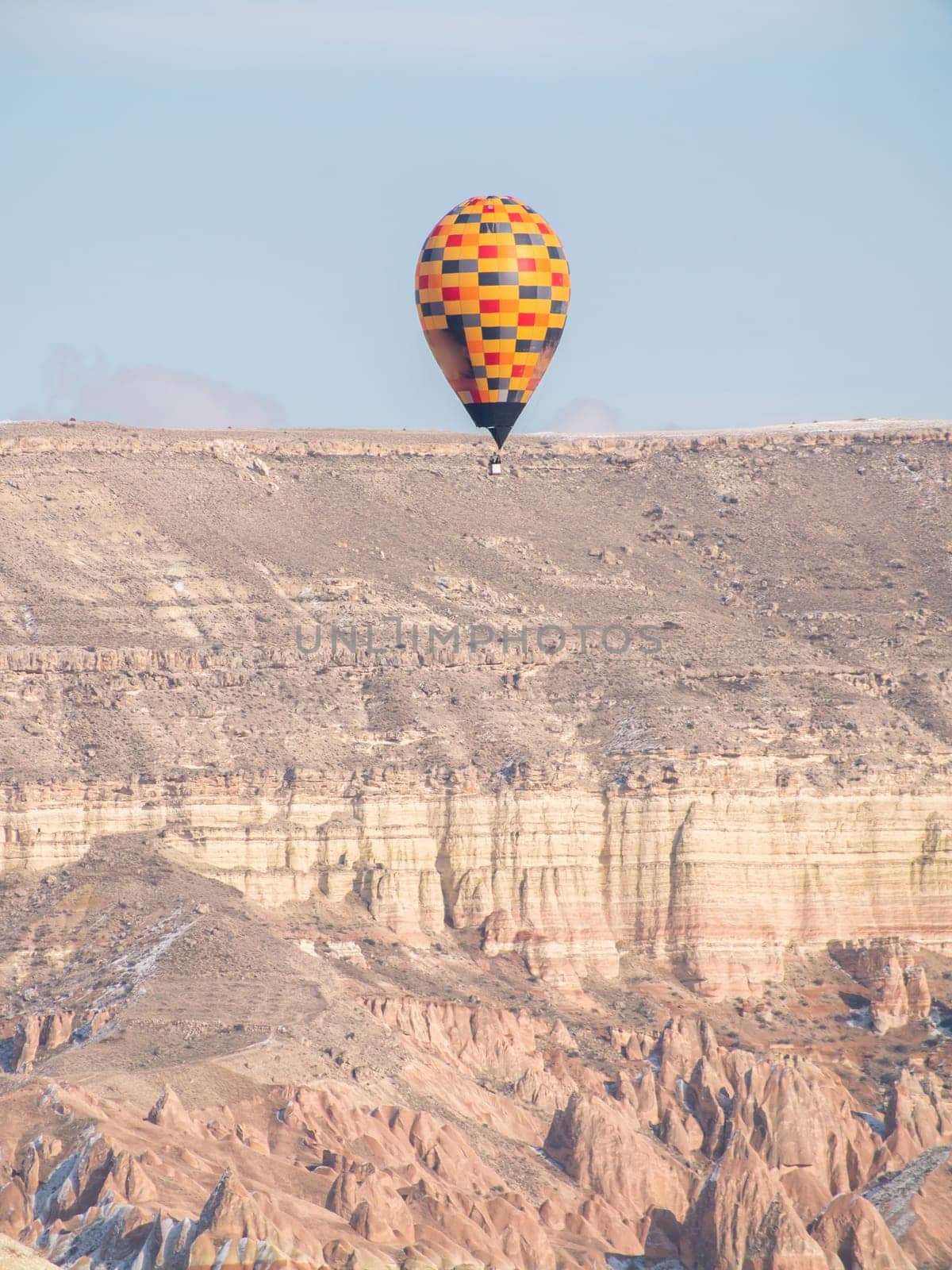 Colorful balloons over volcanic rocks in Cappadocia. Turkey. by DovidPro