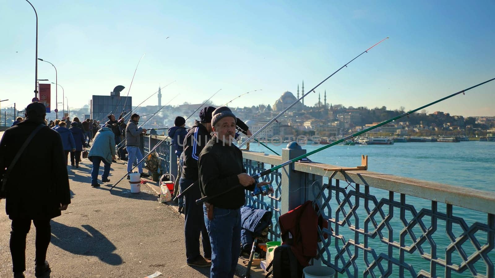 Fishermen catch fish on the bridge in city Istanbul