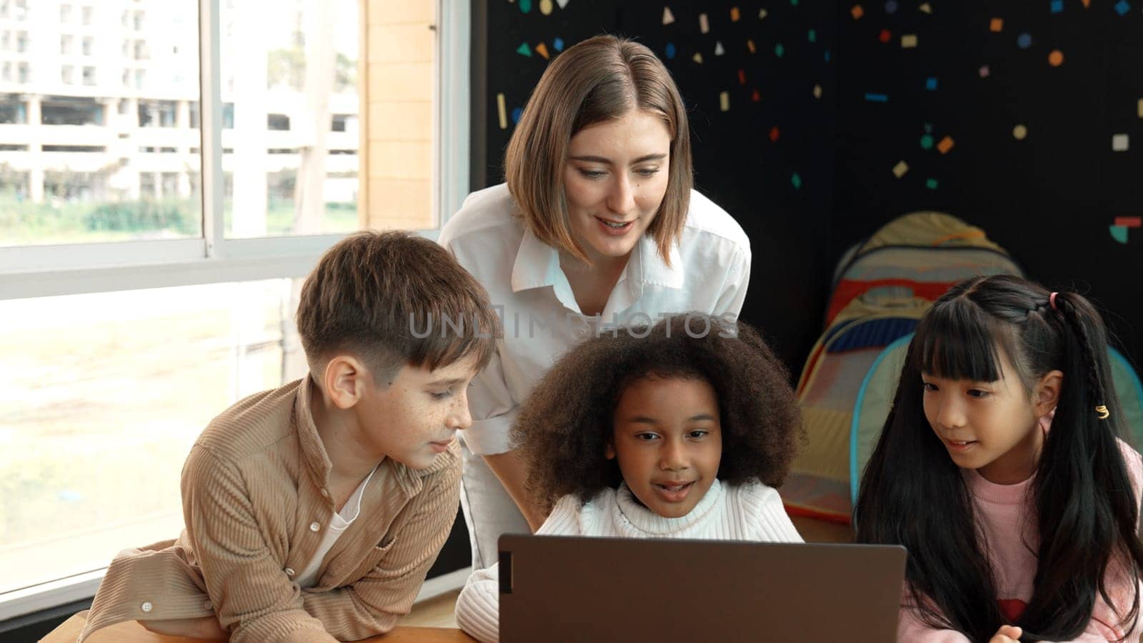 Smart teacher checking student answer while learner using laptop to doing homework, analysis data, programing engineering code and prompt, studying computer system at STEM technology class. Erudition.