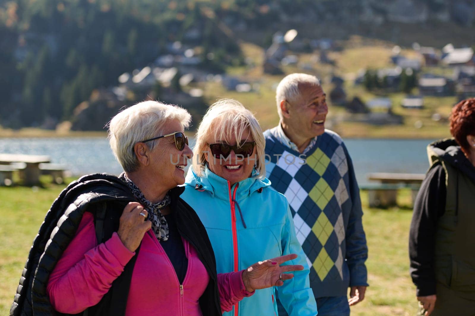 A family shares delightful moments with their friends amid the stunning landscapes of mountains, lakes, and winding paths, promoting a healthy lifestyle and the joy of familial bonds in the embrace of nature's beauty.