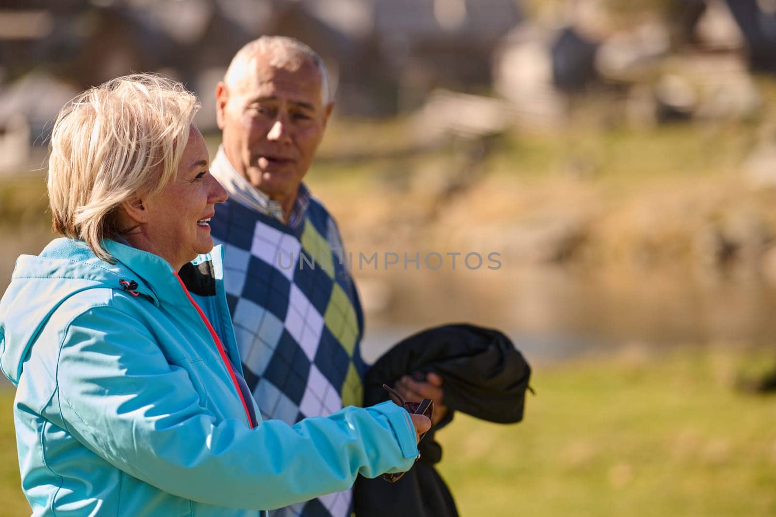 Elderly couple strolling through the breathtaking beauty of nature, maintaining their vitality and serenity, embracing the joys of a health-conscious and harmonious lifestyle.