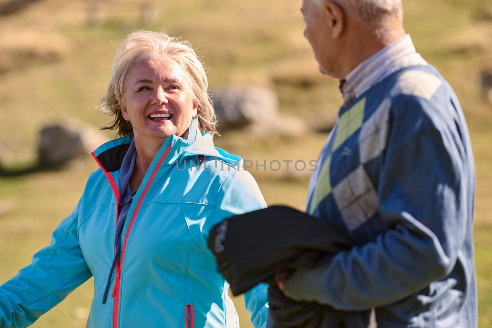 Elderly couple strolling through the breathtaking beauty of nature, maintaining their vitality and serenity, embracing the joys of a health-conscious and harmonious lifestyle by dotshock