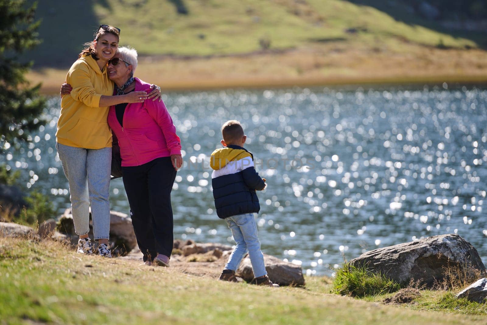 A family shares delightful moments with their friends amid the stunning landscapes of mountains, lakes, and winding paths, promoting a healthy lifestyle and the joy of familial bonds in the embrace of nature's beauty.