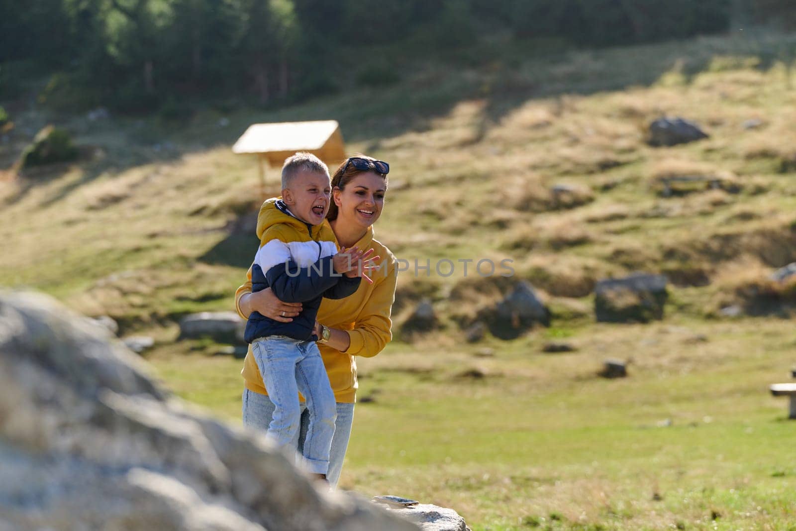 A mother and son create cherished memories as they playfully engage in outdoor activities, their laughter echoing the joy of shared moments and the bond between parent and child.