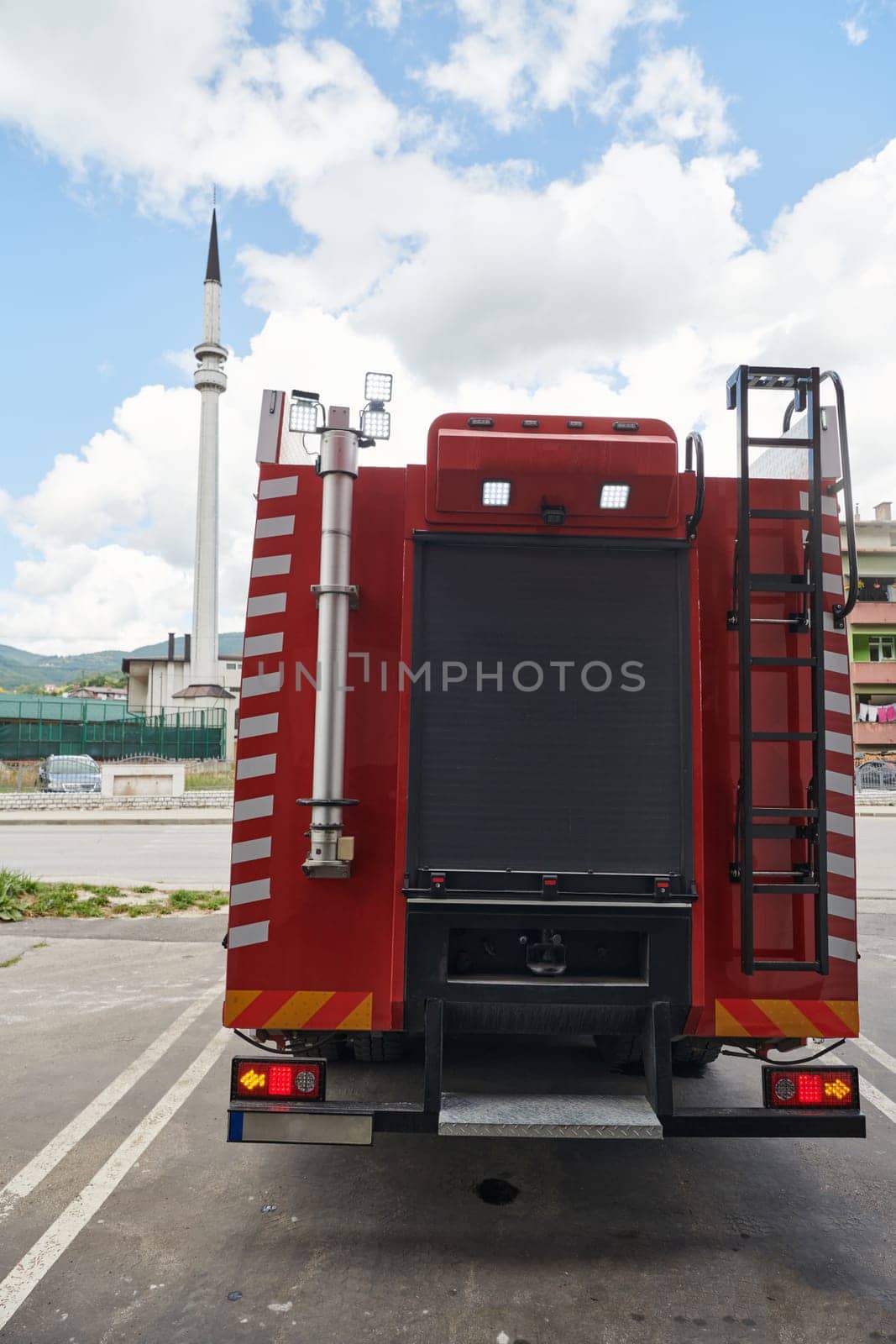 A state-of-the-art firetruck, equipped with advanced rescue technology, stands ready with its skilled firefighting team, prepared to intervene and respond rapidly to emergencies, ensuring the safety and protection of the community. High quality photo