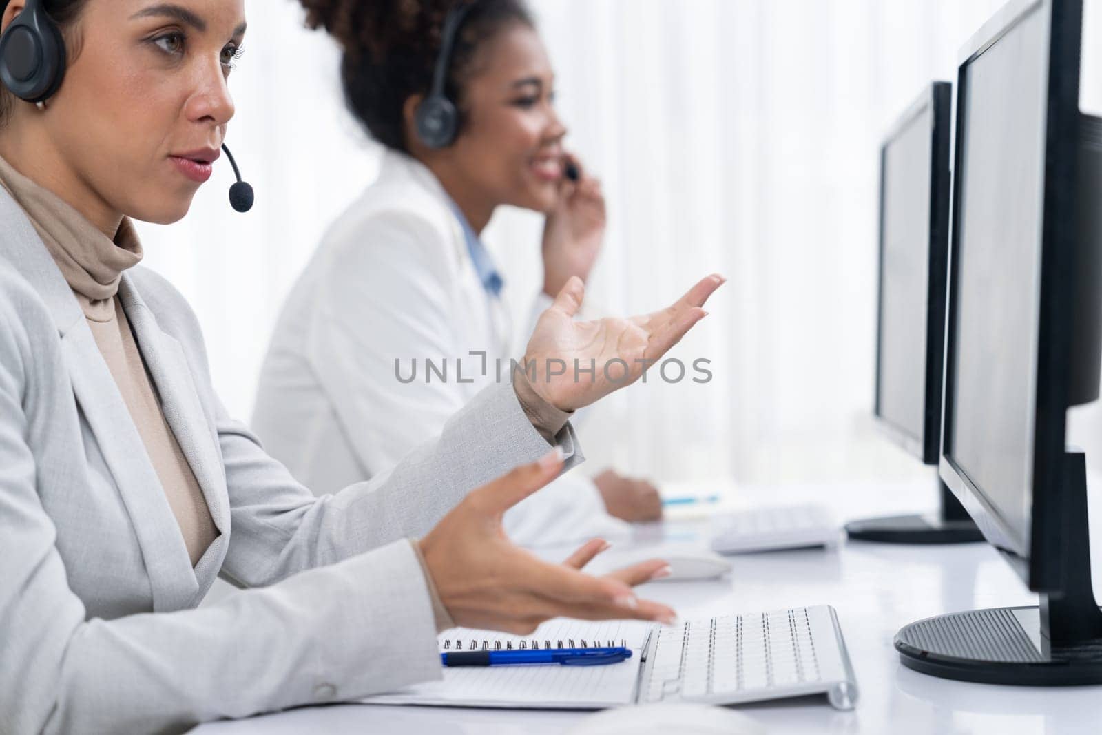 Business people wearing headset working in crucial office by biancoblue